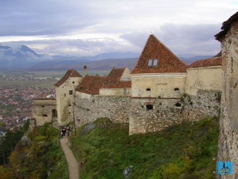 The impressive Râşnov Citadel with Râşnov City on the left